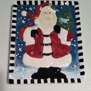 Santa carrying a Christmas tree plate